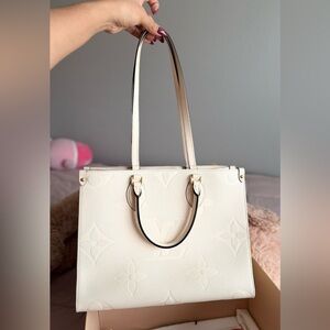 LV ONTHEGO CREAM MONOGRAM PM